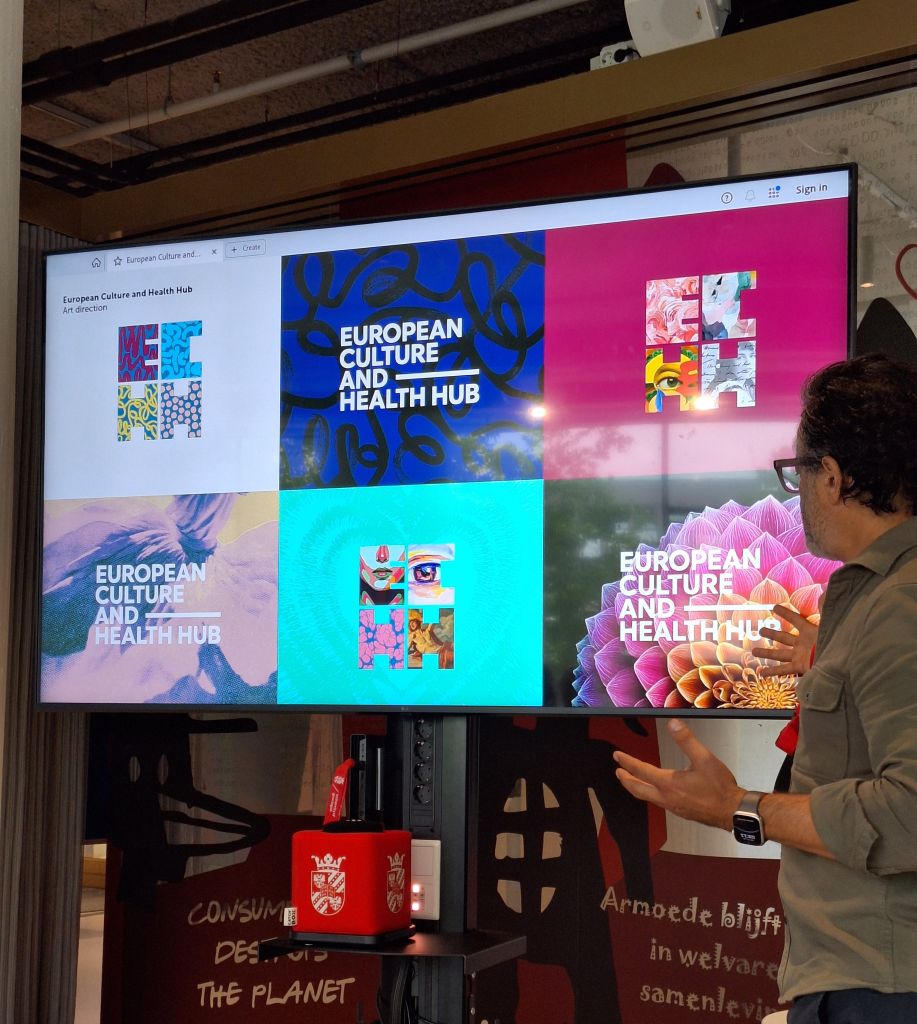 Person presenting in front of a screen with different logo options.